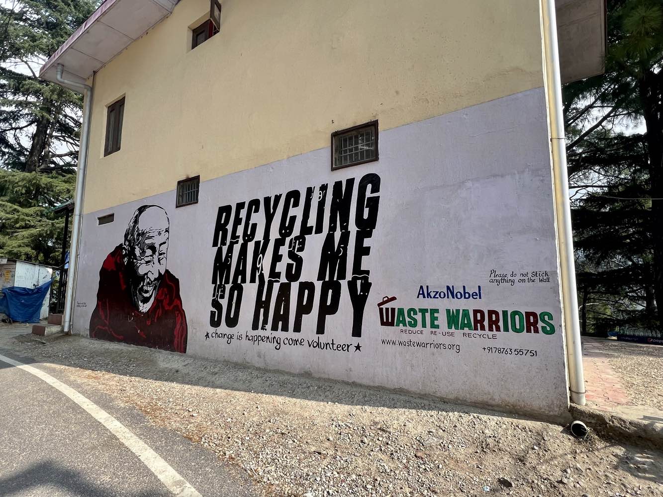 Street art promoting recycling and depicting the Dalai Lama in Dharamshala, India